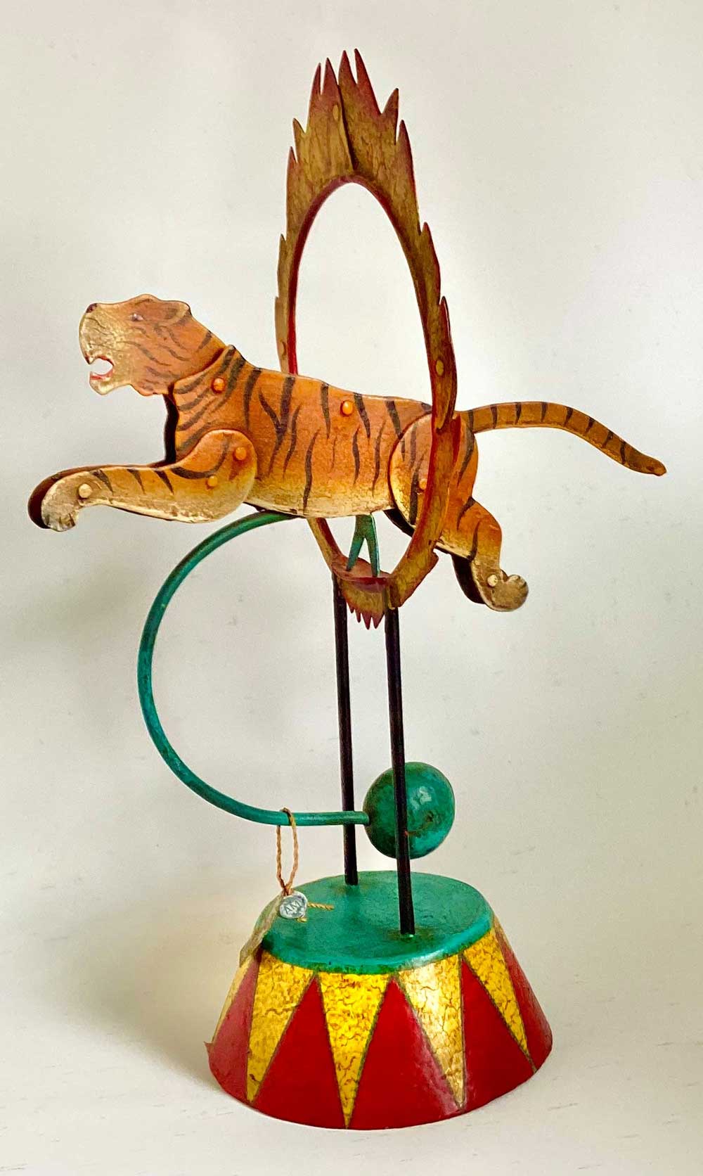 Photo: Moving tiger figure jumping through a flaming hoop